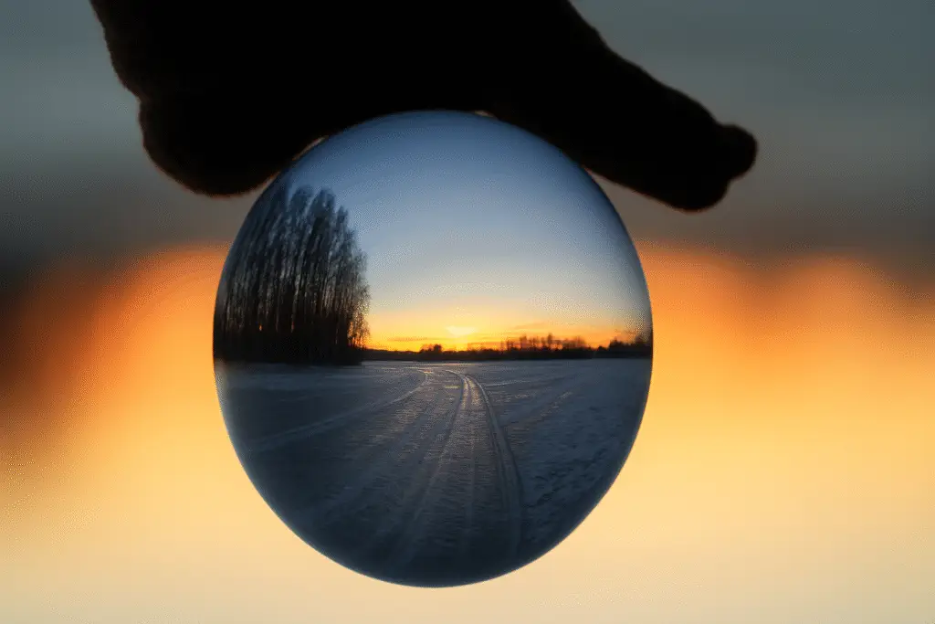 Crystal ball showing AI demand forecasting concept with sunset reflection.